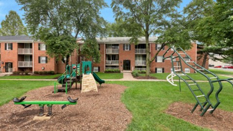 an aerial view of a playground in front of an apartment building