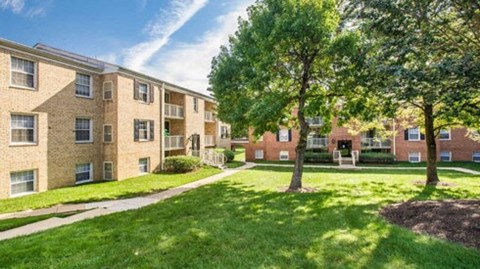 a painting of a building with trees in front of it