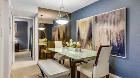 a blurry photo of a dining room with a table and chairs