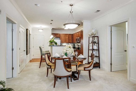 A dining room with a table set for six people.