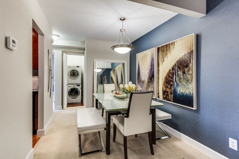 A dining room with a table and chairs.