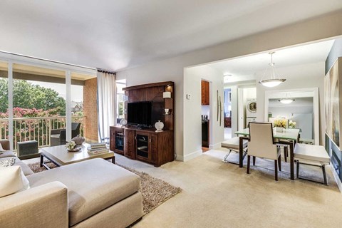 A living room with a white couch and a television.