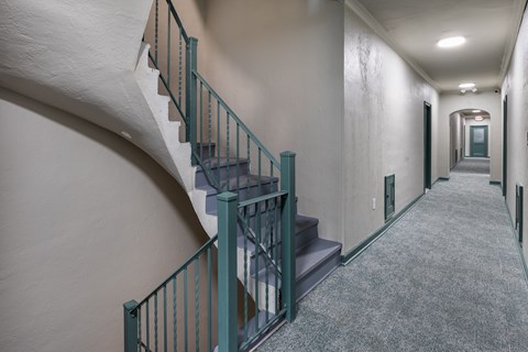 A staircase with a green railing at Marleigh apartments located in Indianapolis, IN