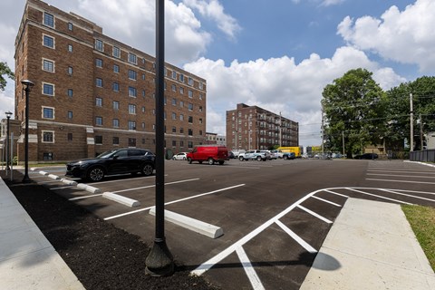 A parking lot with uncovered parking for tenants  at Marleigh apartments located in Indianapolis, IN