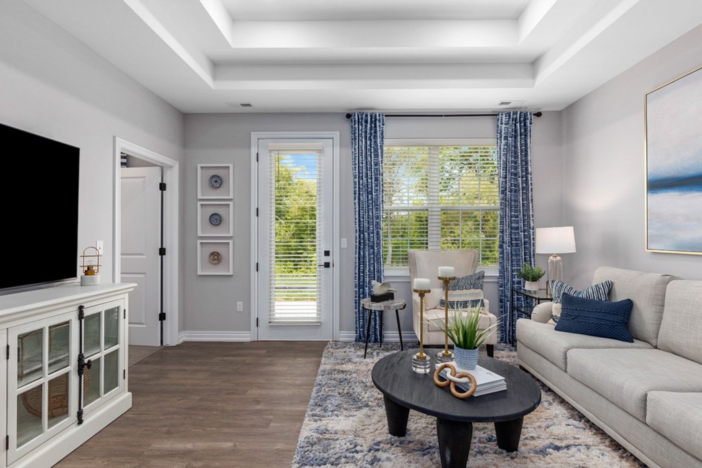 Living room gorgeous Decor, and a television on a cabinet at Encore at West Valley, White Lake, MI