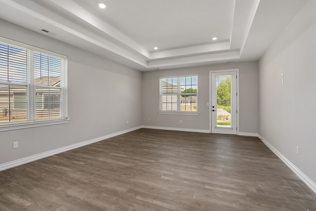 Living room with light wood flooring and white walls Living room with light wood flooring and white walls at Encore at West Valley, Michigan