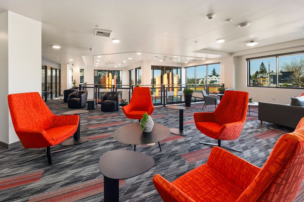 A room with red chairs and a table.