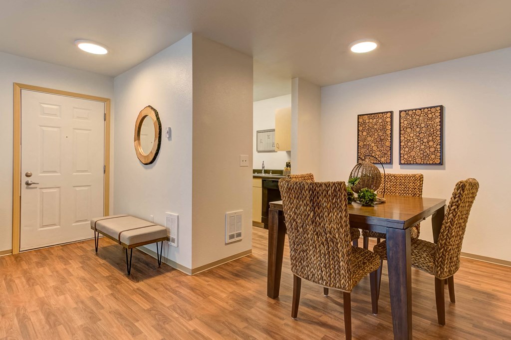 a dining room and kitchen with a table and chairs