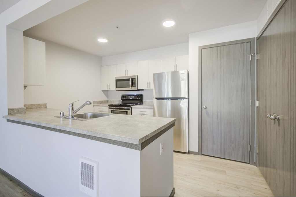 Kitchen Kitchen with refrigerator, oven, microwave, and sink