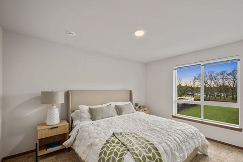 Primary bedroom inside a model apartment at Kendrick Landing Apartments