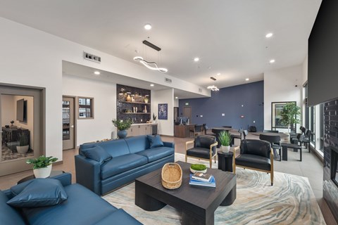 A modern living room with a dark blue sofa and a coffee table.