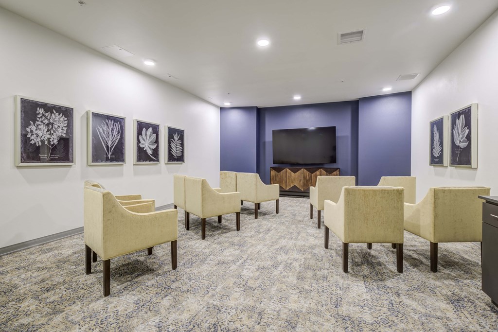 a large room with chairs and a television in the center of it at Ovation at Meeker, Washington, 98032