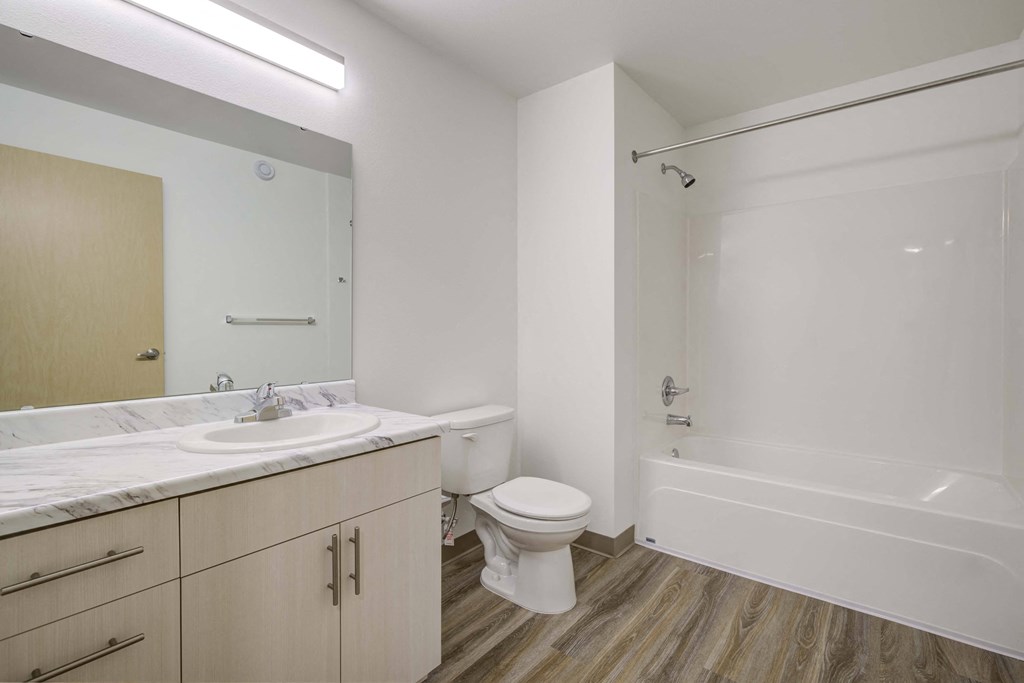a bathroom with a sink toilet and bath tub at Ovation at Meeker, Kent 