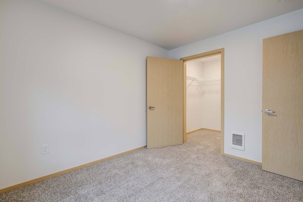 an empty room with a door to a closet at Ovation at Meeker, Kent, 98032