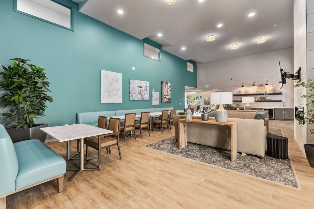 A room with a dining table and chairs.