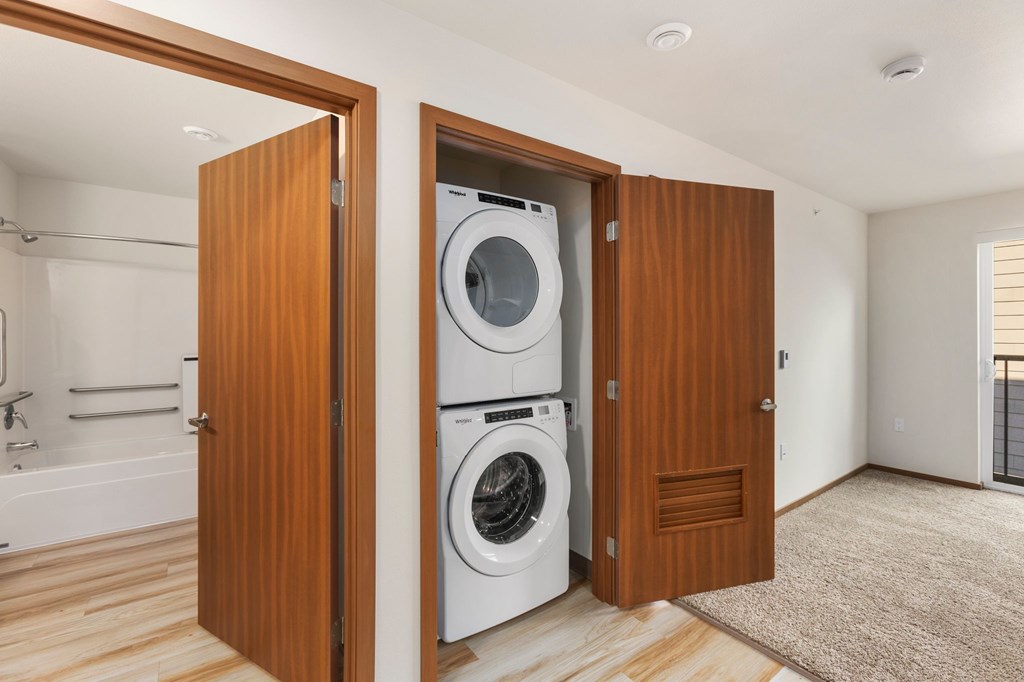 A washing machine is in a wooden door.