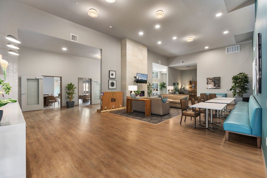 A spacious room with wooden floors and furniture.
