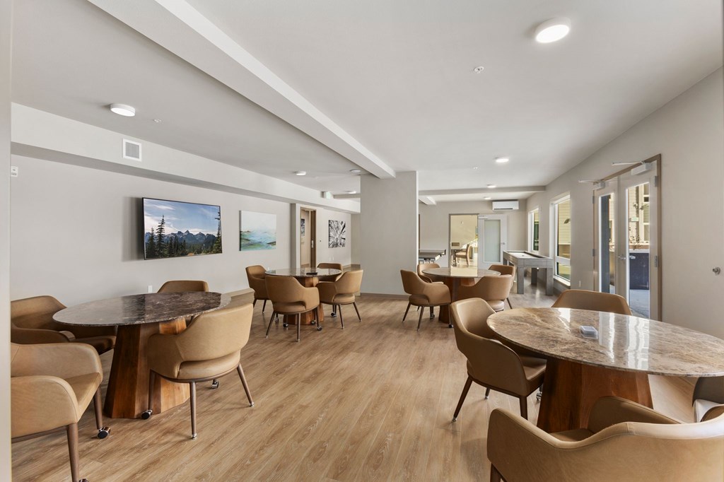 A modern dining room with a large table and chairs.