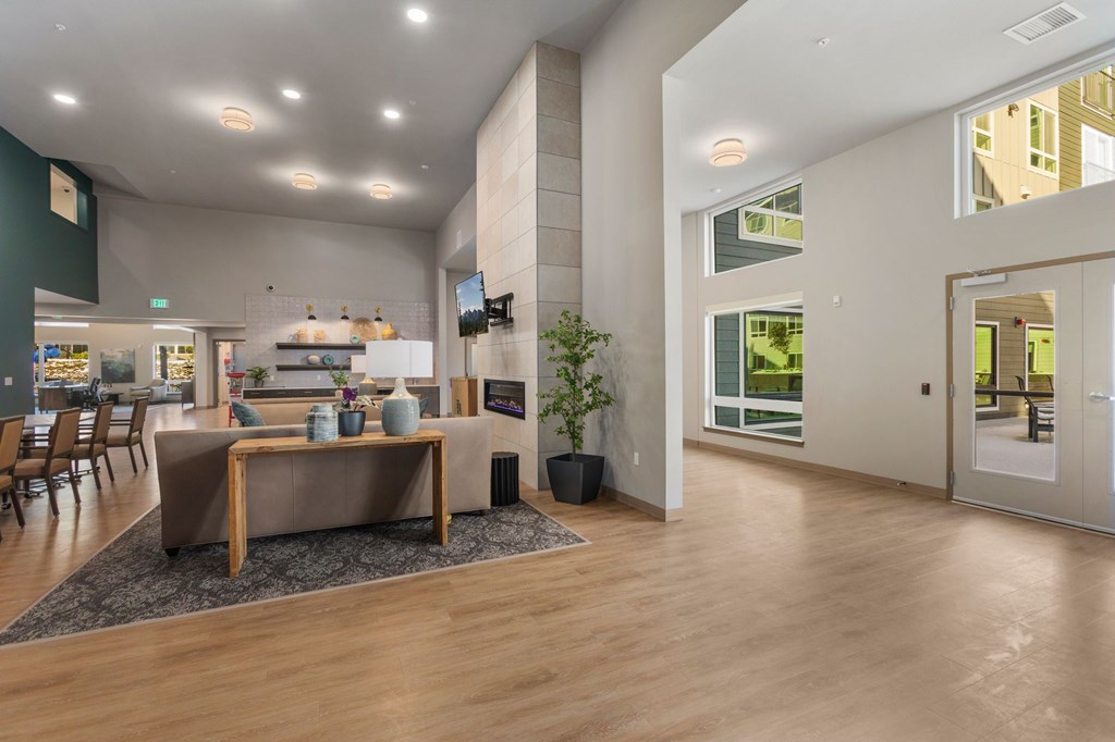 A modern living room with a wooden floor and a large window.