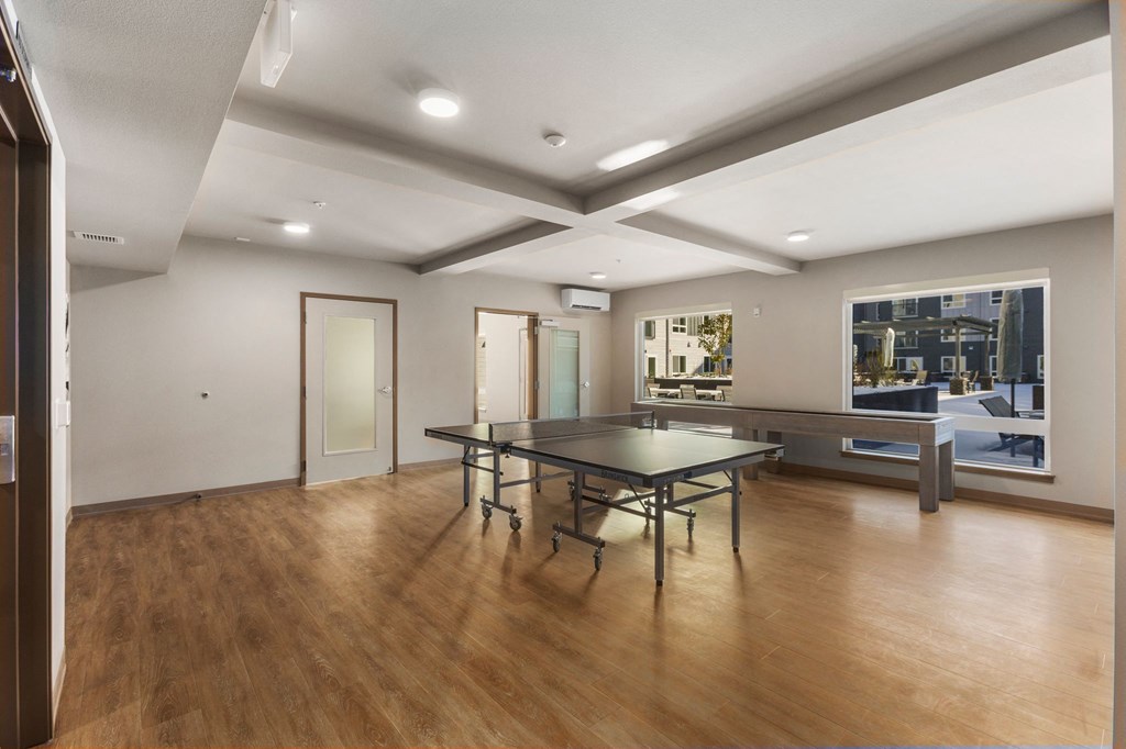 A conference room with a long table and chairs.