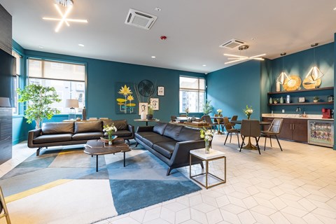 a living room with blue walls and leather furniture