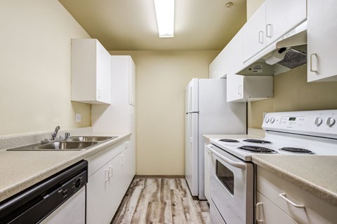 a kitchen with white appliances and white cabinets