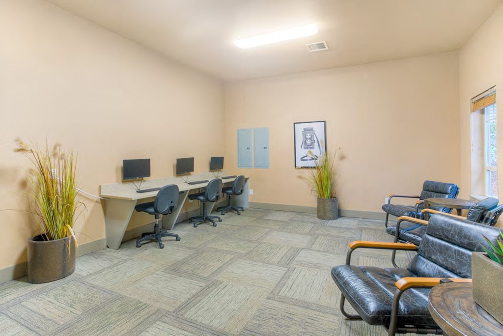 a conference room with desks and chairs and a window