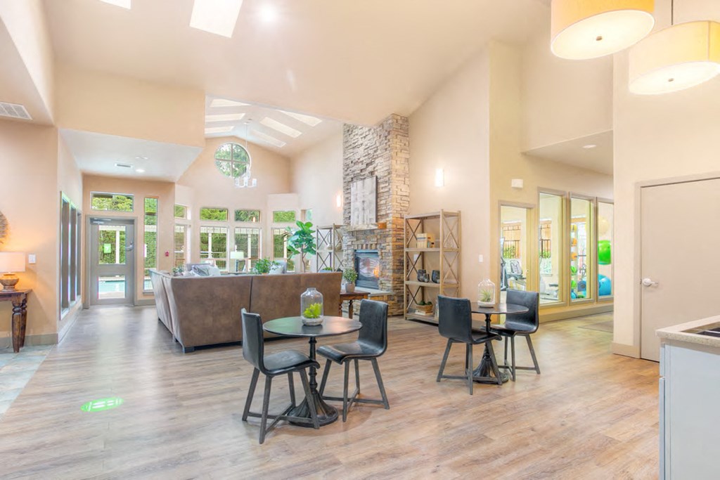 a large living room with tables and chairs and a fireplace