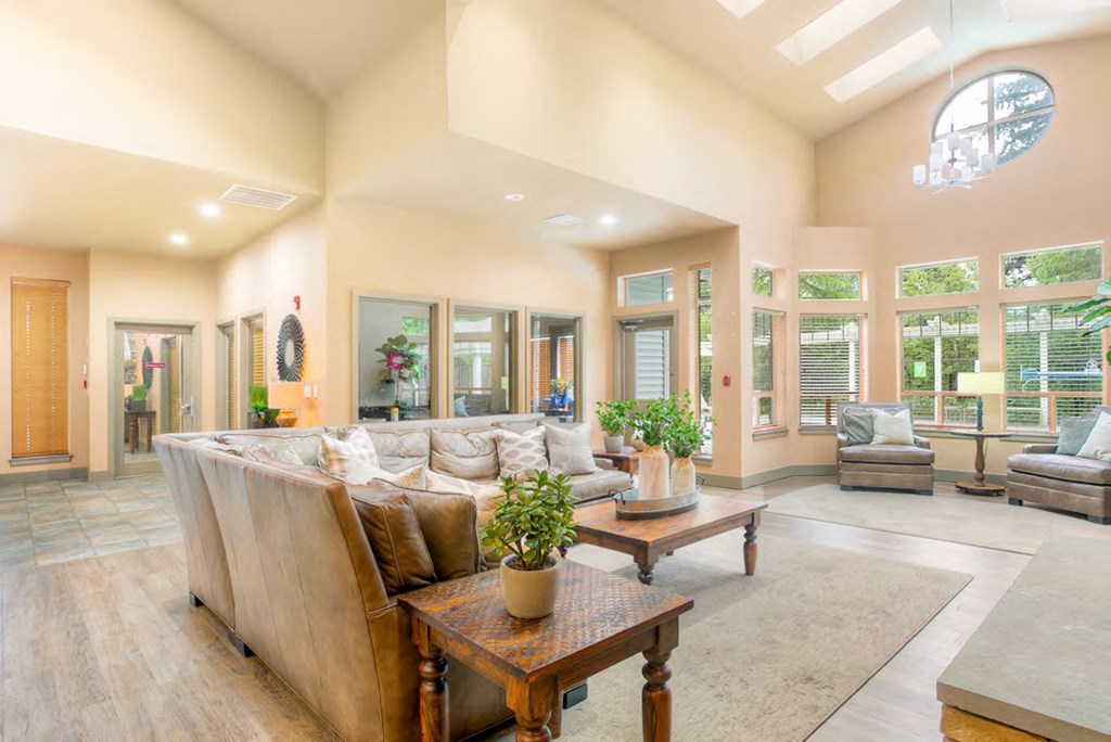 a large living room with a couch and a table