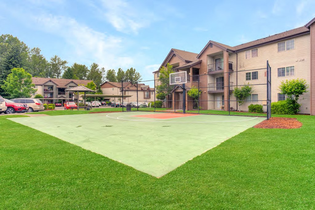 a basketball court in front of a apartment building
