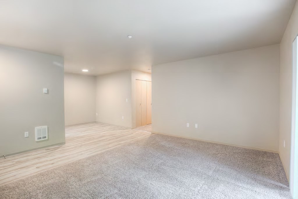 the living room and dining room are empty and ready to be staged