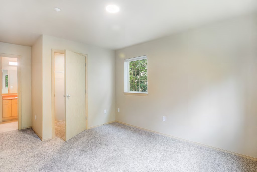 a empty room with a window and a door