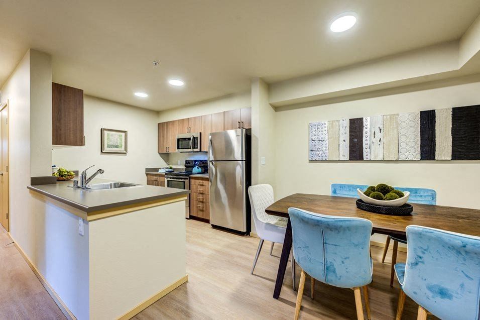 a kitchen and dining room with a table and chairs