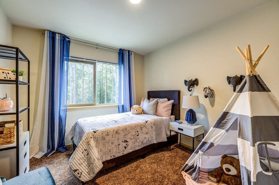 a bedroom with a bed and a tent