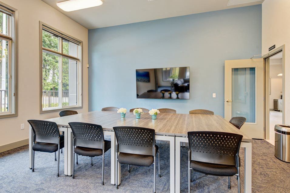 a conference room with a large table and chairs