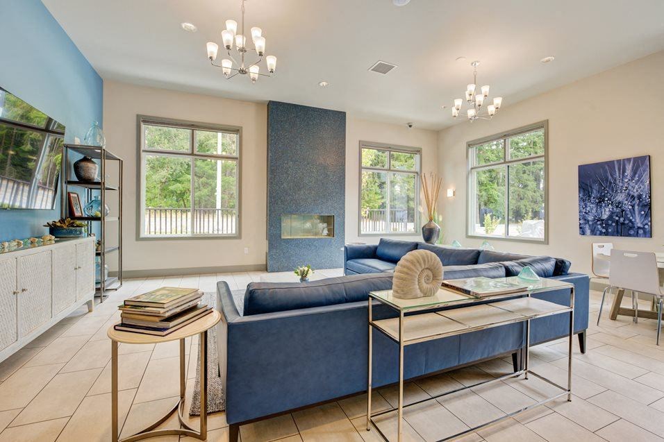 a living room with a blue couch and a table