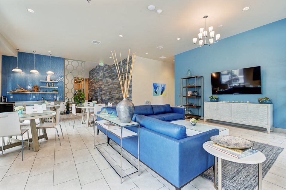 a living room with blue furniture and a television