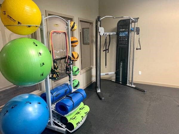 a gym with weights and other equipment in a room
