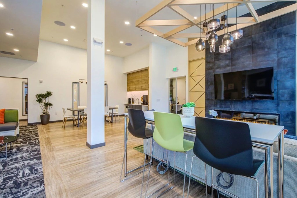 A modern office space with a fireplace and a bar area.