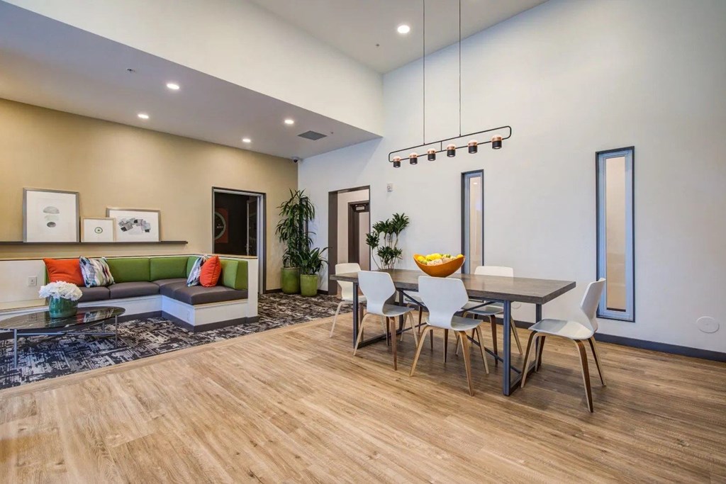 A modern dining area with a wooden table and chairs.