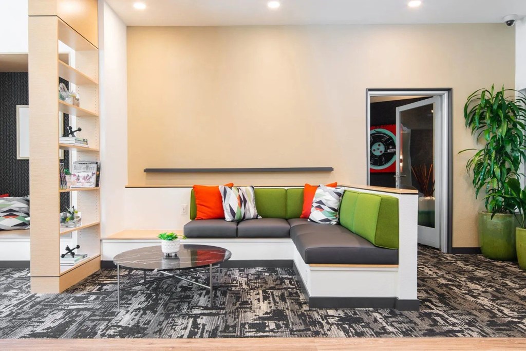 A modern living room with a grey sofa and a coffee table.