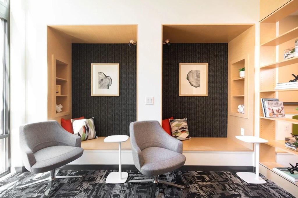 A living room with two chairs and a table.