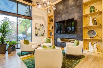 A living room with a fireplace and a TV mounted on the wall.