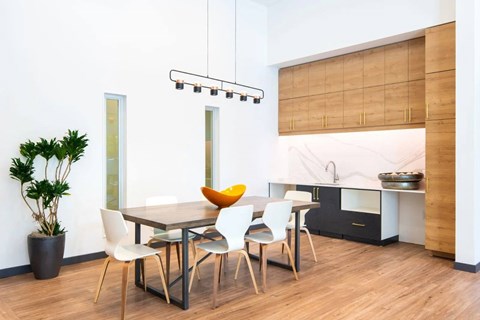 A modern dining room with a wooden table and chairs.
