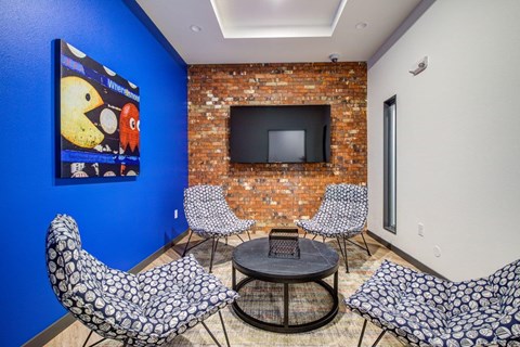 A living room with a blue wall and a television.