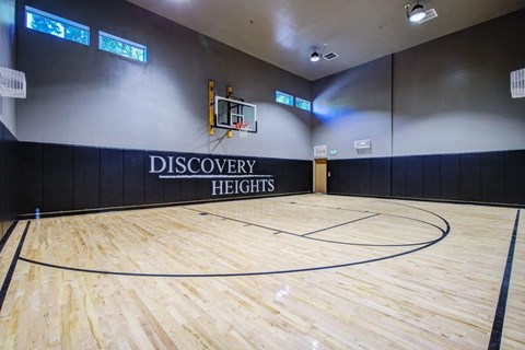 A basketball court with the words "Discovery Heights" on the wall.