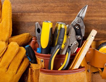 A tool belt with various tools in it.
