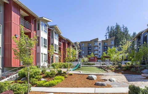 A red building with a green lawn in front.