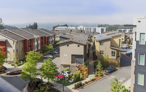 A view of a residential area with houses and cars.