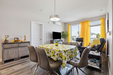 A dining room with a table set for four.